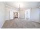 Large living room with plush carpeting, chandelier, bay window, decorative molding and entryways at 11034 W Sierra Pinta Dr, Peoria, AZ 85373