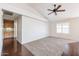Spacious living room offers a ceiling fan, plush carpeting, and bright windows at 11034 W Sierra Pinta Dr, Peoria, AZ 85373