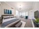 Spacious main bedroom with plush carpeting, chandelier, bay window, and a serene blue and gray color scheme at 11034 W Sierra Pinta Dr, Peoria, AZ 85373