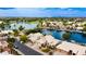 Waterfront home aerial view of this beautiful property with waterfront views surrounded by palm trees and lush landscaping at 1146 W Sea Fog Dr, Gilbert, AZ 85233