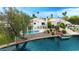 This outdoor oasis features a private pool, boat dock, and waterfront access surrounded by lush landscaping at 1146 W Sea Fog Dr, Gilbert, AZ 85233