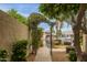 Scenic backyard with a view of the serene lake, lush greenery, and charming garden path at 1146 W Sea Fog Dr, Gilbert, AZ 85233