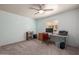 Study features plush neutral carpeting, a ceiling fan, and a large desk space with natural lighting at 1146 W Sea Fog Dr, Gilbert, AZ 85233