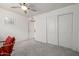 Bedroom features plush neutral carpeting, a ceiling fan, and closet space with sliding doors at 1146 W Sea Fog Dr, Gilbert, AZ 85233