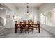 Elegant dining room with a stylish pendant light fixture and large windows at 1146 W Sea Fog Dr, Gilbert, AZ 85233