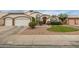 Well-maintained house showcasing a manicured front lawn, desert landscaping, and a two-car garage at 1146 W Sea Fog Dr, Gilbert, AZ 85233