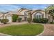 An inviting exterior view showcasing a well-maintained lawn, desert landscaping, and a charming facade at 1146 W Sea Fog Dr, Gilbert, AZ 85233