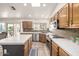 Well-lit kitchen with island, wood cabinets, stainless steel appliances and backyard views at 1146 W Sea Fog Dr, Gilbert, AZ 85233