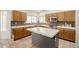 Functional kitchen featuring wood cabinets, tiled countertops, and stainless steel appliances at 1146 W Sea Fog Dr, Gilbert, AZ 85233