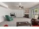 Open living room with plush carpet, fireplace, ceiling fan, and sliding glass doors for natural light at 1146 W Sea Fog Dr, Gilbert, AZ 85233
