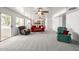 Spacious living room with plush carpet, ceiling fans, and access to balcony area at 1146 W Sea Fog Dr, Gilbert, AZ 85233