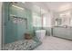 Stunning bathroom featuring a glass-enclosed shower, soaking tub, and stylish vanity at 1146 W Sea Fog Dr, Gilbert, AZ 85233