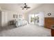 Bright main bedroom with vaulted ceiling, ceiling fan, and balcony access at 1146 W Sea Fog Dr, Gilbert, AZ 85233