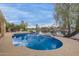 Sparkling blue pool with a view of the lake, surrounded by lush greenery and palm trees at 1146 W Sea Fog Dr, Gilbert, AZ 85233