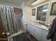 This bathroom features neutral tones, a shower stall with curtain and a white sink cabinet at 120 N Val Vista Dr # 151, Mesa, AZ 85213