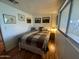 Cozy bedroom boasts natural light and features a bed with a quilt and vintage-style artwork at 120 N Val Vista Dr # 151, Mesa, AZ 85213