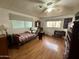 A bedroom with wood-look floors, a ceiling fan, and a large window at 120 N Val Vista Dr # 151, Mesa, AZ 85213