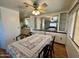 Bright dining room features a ceiling fan, built-in cabinets, and a large window, creating an inviting space at 120 N Val Vista Dr # 151, Mesa, AZ 85213