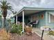 Charming home featuring a covered porch, well-maintained landscaping, and inviting curb appeal at 120 N Val Vista Dr # 151, Mesa, AZ 85213