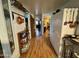 Hallway featuring wood floors, storage cabinets, and copper cookware displayed on the wall at 120 N Val Vista Dr # 151, Mesa, AZ 85213