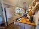 Cozy kitchen features white cabinets, wood countertops and decorative copper cookware displayed on the wall at 120 N Val Vista Dr # 151, Mesa, AZ 85213
