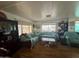 Spacious living room with laminate flooring, bright lighting, and comfortable seating at 120 N Val Vista Dr # 151, Mesa, AZ 85213