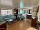 Comfortable living room featuring laminate flooring, lots of natural light, and cozy furniture at 120 N Val Vista Dr # 151, Mesa, AZ 85213
