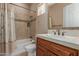 Bathroom featuring a shower-tub combination, neutral tiling, and a decorative mirror at 1260 E Sweet Citrus Dr, Queen Creek, AZ 85140
