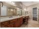 Bright primary bathroom featuring dual sinks, tiled countertops and backsplash, and a decorative mirror at 1260 E Sweet Citrus Dr, Queen Creek, AZ 85140