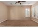 Well-lit bedroom features plush carpeting, neutral walls, and bright windows with shutter-style blinds at 1260 E Sweet Citrus Dr, Queen Creek, AZ 85140