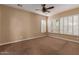 Spacious bedroom with plush carpeting, neutral walls, and bright windows with shutter-style blinds at 1260 E Sweet Citrus Dr, Queen Creek, AZ 85140