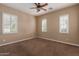 Comfortable bedroom featuring plush carpeting, neutral walls, and bright windows with shutter-style blinds at 1260 E Sweet Citrus Dr, Queen Creek, AZ 85140
