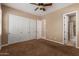 Bedroom features neutral walls, plush carpeting, and a closet with sliding doors at 1260 E Sweet Citrus Dr, Queen Creek, AZ 85140
