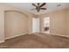 Bedroom featuring neutral walls, plush carpeting, and an arched entrance leading to the bathroom at 1260 E Sweet Citrus Dr, Queen Creek, AZ 85140