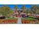 Beautiful community entrance featuring a water fountain, lush greenery, and manicured landscaping at 1260 E Sweet Citrus Dr, Queen Creek, AZ 85140