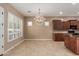 Open dining room with elegant chandelier, shutters, and connection to the kitchen space at 1260 E Sweet Citrus Dr, Queen Creek, AZ 85140