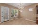 Bright dining room featuring a stunning chandelier and large windows with white shutters at 1260 E Sweet Citrus Dr, Queen Creek, AZ 85140