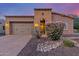 Charming single-Gathering home with a well-manicured front yard and a two-car garage at 1260 E Sweet Citrus Dr, Queen Creek, AZ 85140
