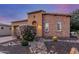 A well landscaped home showcasing rock features, desert plants and brick and stucco facade at 1260 E Sweet Citrus Dr, Queen Creek, AZ 85140