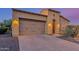 Beautiful home featuring a paved driveway, two-car garage, and desert landscaping at 1260 E Sweet Citrus Dr, Queen Creek, AZ 85140