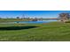 Scenic golf course view featuring a pond with rock features and lush green grass at 1260 E Sweet Citrus Dr, Queen Creek, AZ 85140