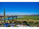 Scenic golf course view with a pergola, pond, and well-maintained greens, perfect for relaxation at 1260 E Sweet Citrus Dr, Queen Creek, AZ 85140