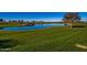 Scenic golf course view featuring a pond with rock features and lush green grass at 1260 E Sweet Citrus Dr, Queen Creek, AZ 85140