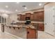 Kitchen island with stunning granite countertop and dark cabinetry at 1260 E Sweet Citrus Dr, Queen Creek, AZ 85140