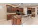 Spacious kitchen island with seating, dark appliances, and granite countertop at 1260 E Sweet Citrus Dr, Queen Creek, AZ 85140