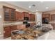 Kitchen island featuring an undermount sink and a stunning countertop and cabinetry at 1260 E Sweet Citrus Dr, Queen Creek, AZ 85140