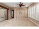 Bright living room with tile flooring, ceiling fan, sliding glass door leading to patio at 1260 E Sweet Citrus Dr, Queen Creek, AZ 85140