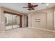 Bright living room with tile flooring, ceiling fan, sliding glass door leading to patio at 1260 E Sweet Citrus Dr, Queen Creek, AZ 85140