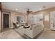 Bright staged living room with tile flooring, modern furnishings and light neutral colors at 1260 E Sweet Citrus Dr, Queen Creek, AZ 85140
