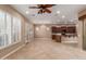 Spacious living area with plantation shutters, elegant chandelier, and tile flooring at 1260 E Sweet Citrus Dr, Queen Creek, AZ 85140